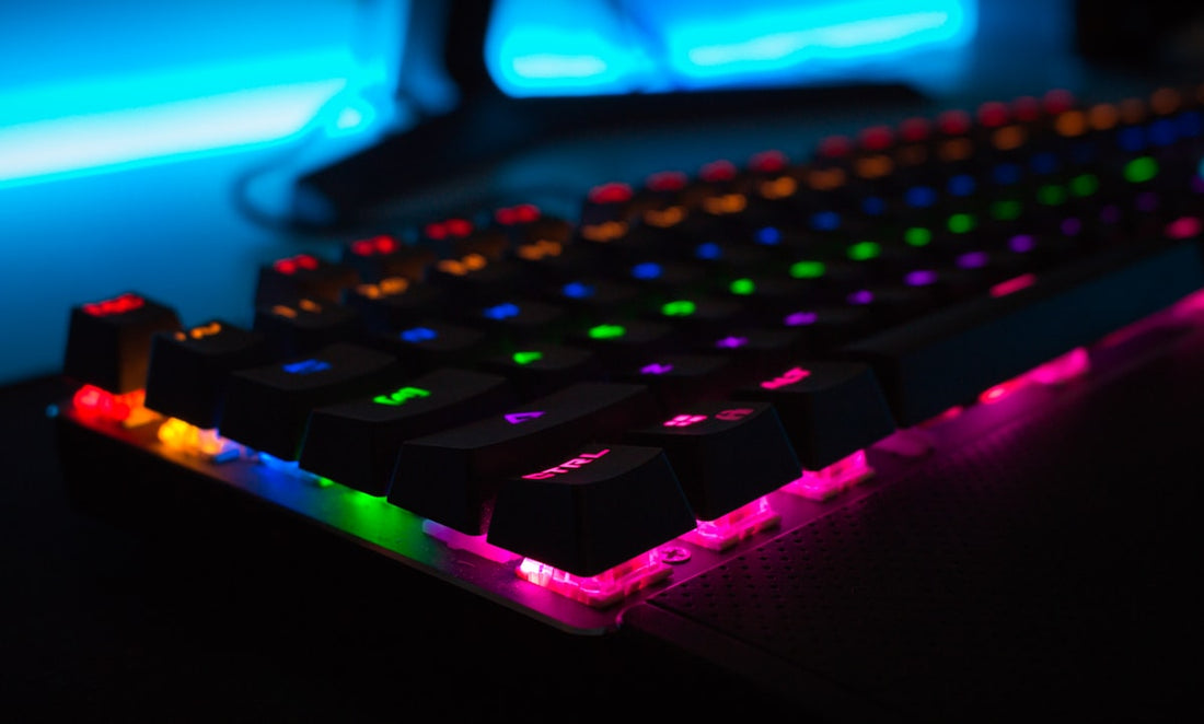 Gaming room desk setup with RGB LED strip lighting and neon accents