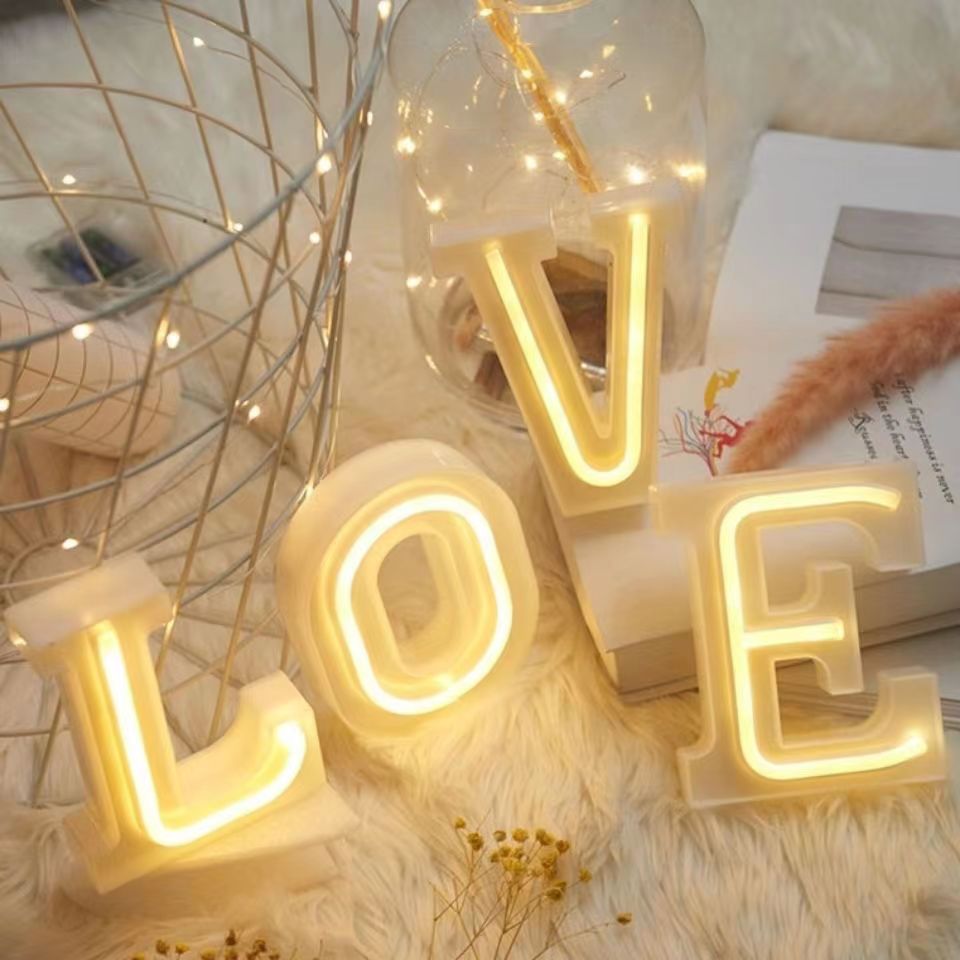LED neon letter A glowing warm white on acrylic base