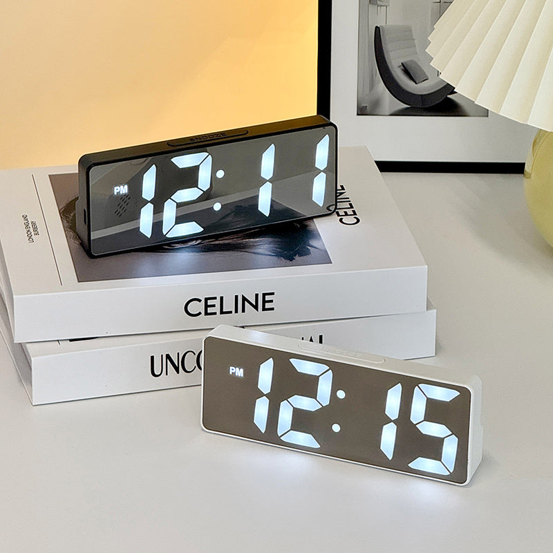 LED alarm clock in white minimalist design on bedside table