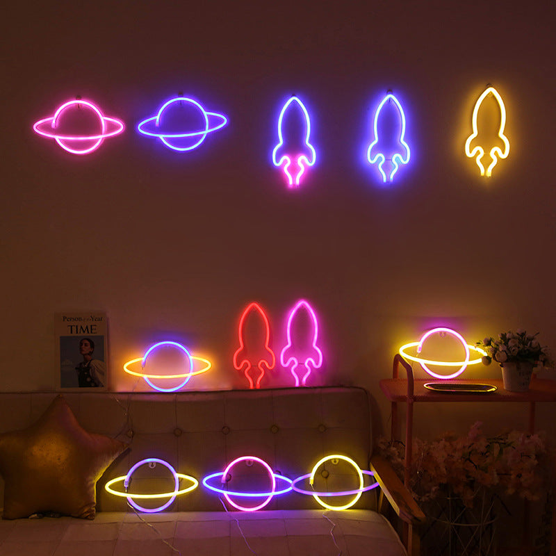 Planet neon light in yellow colour on bedroom shelf