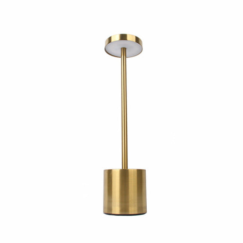 Gold Nordic touch lamp illuminating a minimalist workspace