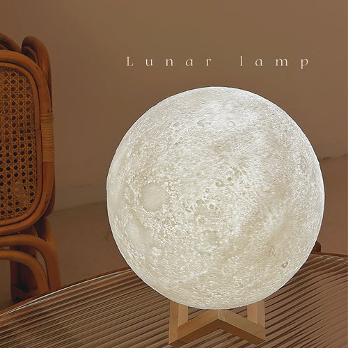 Lumora Moon Lamp glowing warm white on desk with realistic crater detail