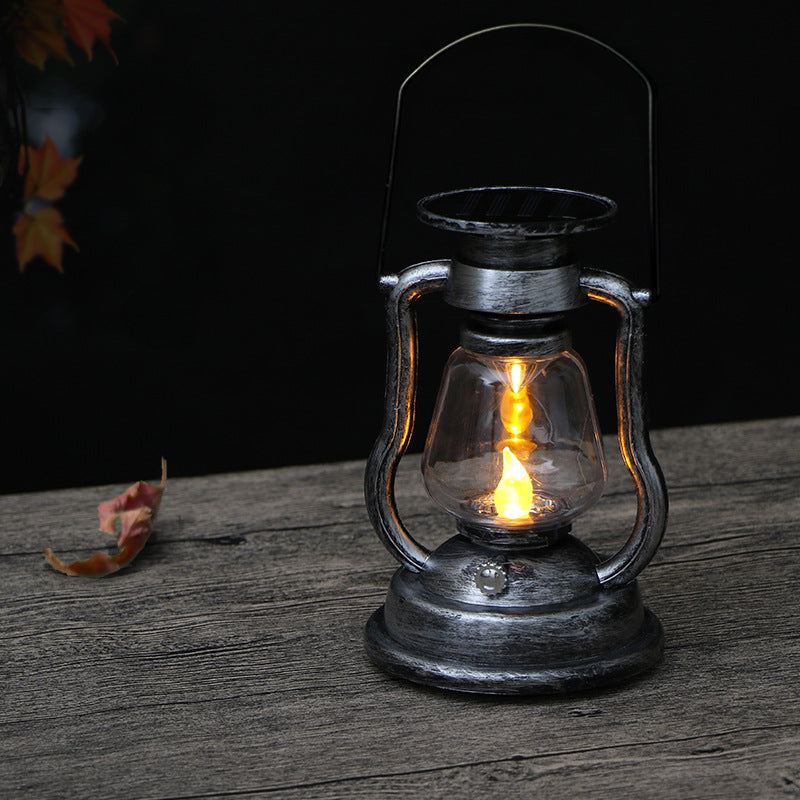 Solar lantern in bronze colour on garden table at night