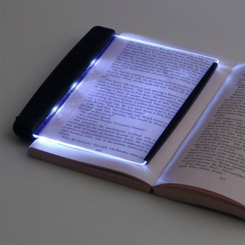 Lumora™ Portable LED Book Light clipped onto a book, warm white glow